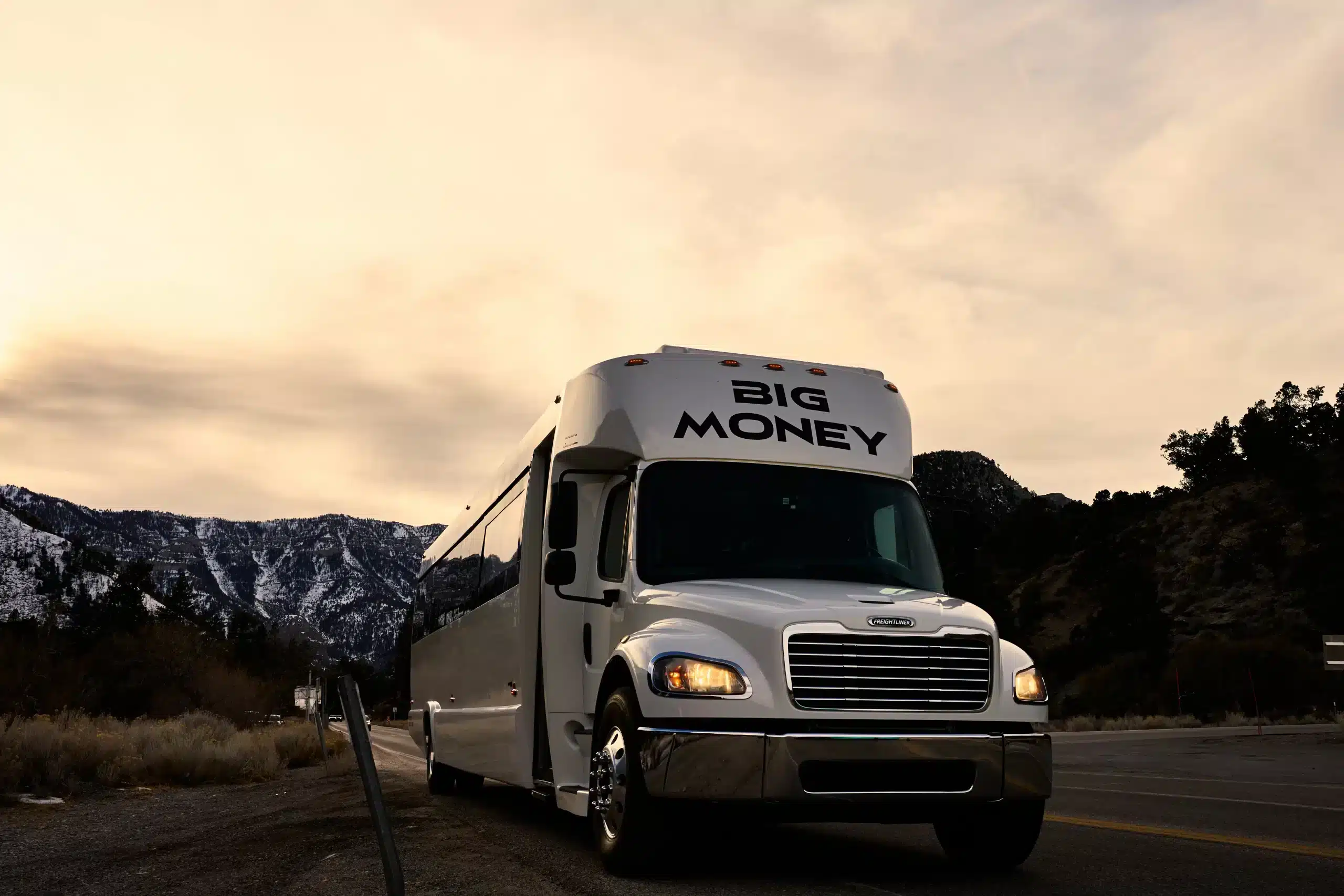 40-passenger Big Money party bus driving along scenic desert roads near Las Vegas — ideal for large group trips and tours.
