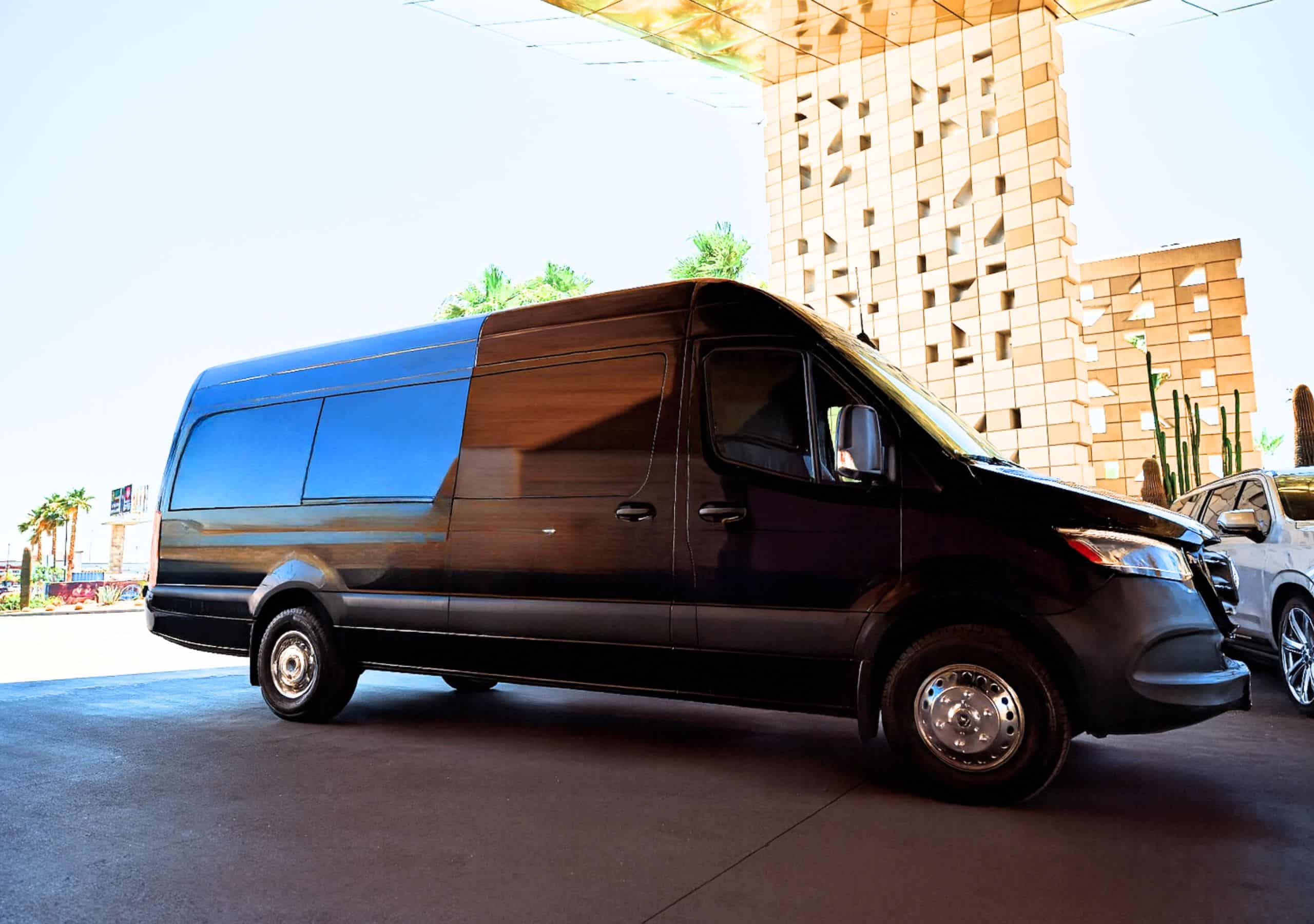 Luxury black Sprinter van at a modern geometric Las Vegas hotel—ideal for VIPs, executives, and small groups.