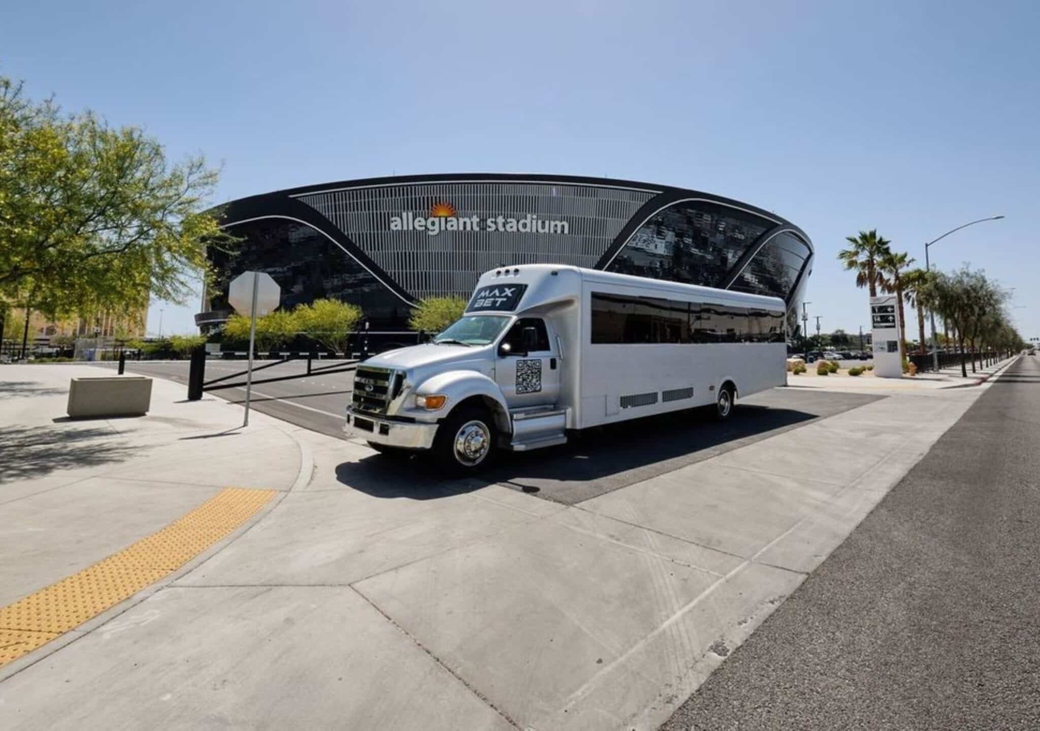 Max Bet 36-passenger white Las Vegas party bus parked in front of Allegiant Stadium — perfect for events, concerts, and group trips.